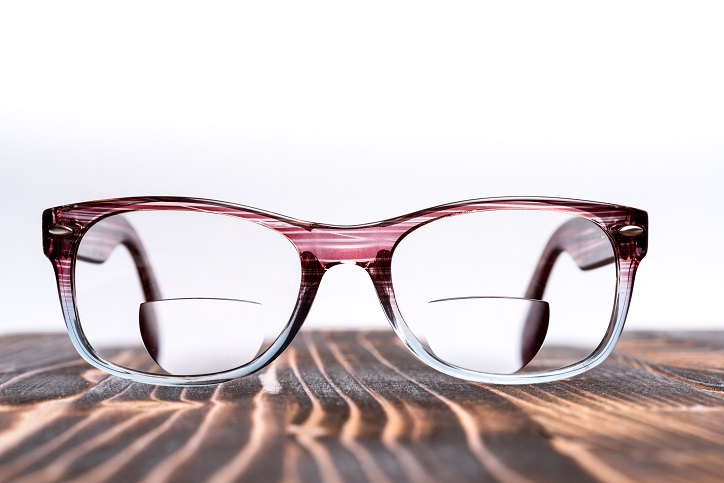 Eyeglasses,With,Bifocal,Lenses,,Plastic,Frame,,On,Wooden,Board